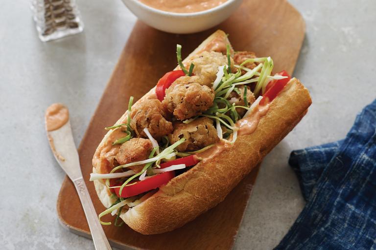 a sandwich roll filled with breaded mushrooms